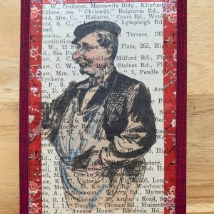 Friendly Grocer in Apron on Antique Book Page 3 x 5" Folkart #CSL9